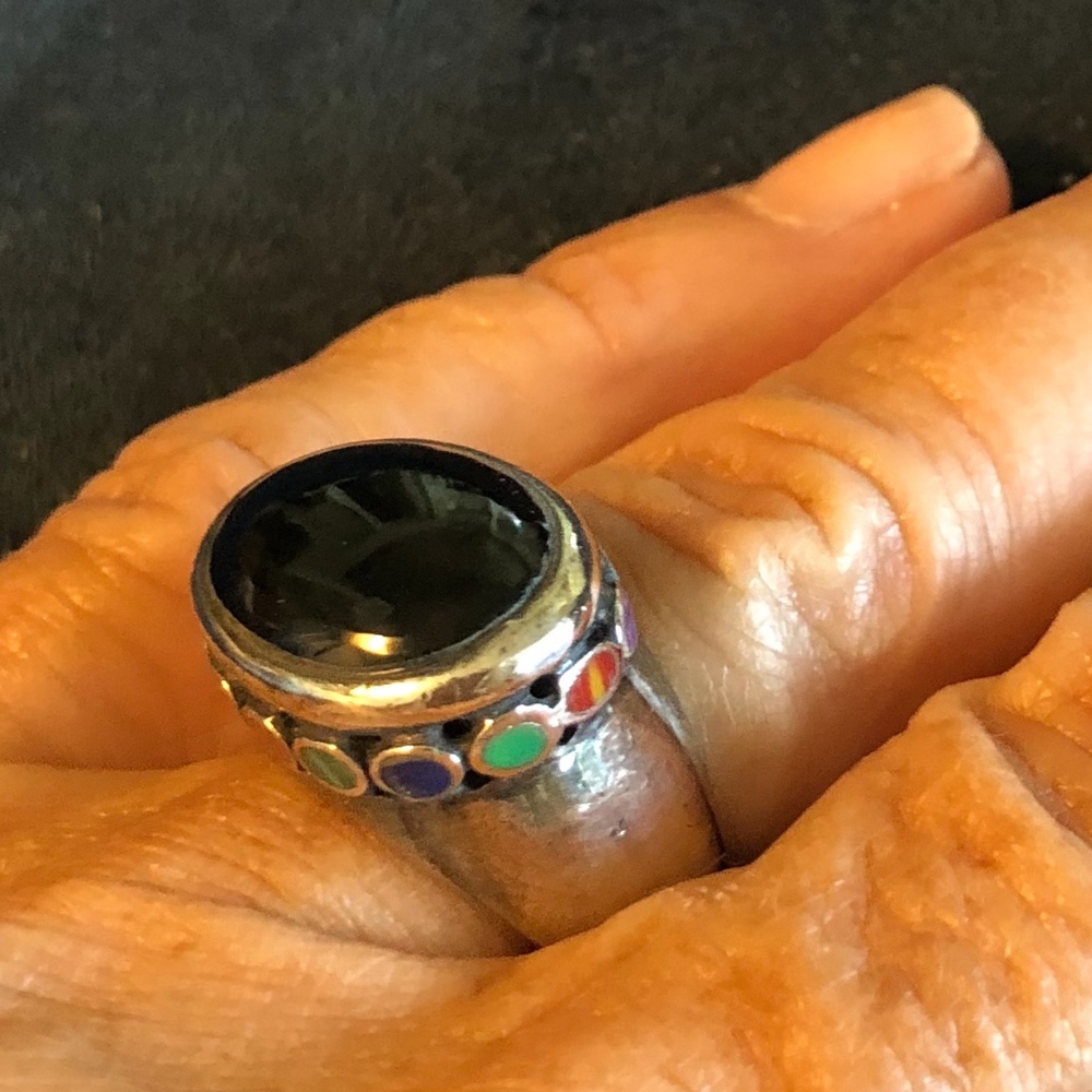 Onyx ring surrounded by many jewel tones